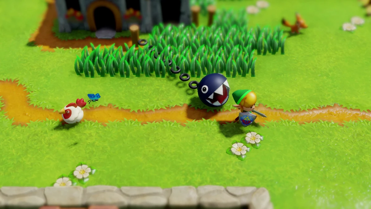 Link guiando a un Chain Chomp por la hierba en el remake diorama de Link’s Awakening
