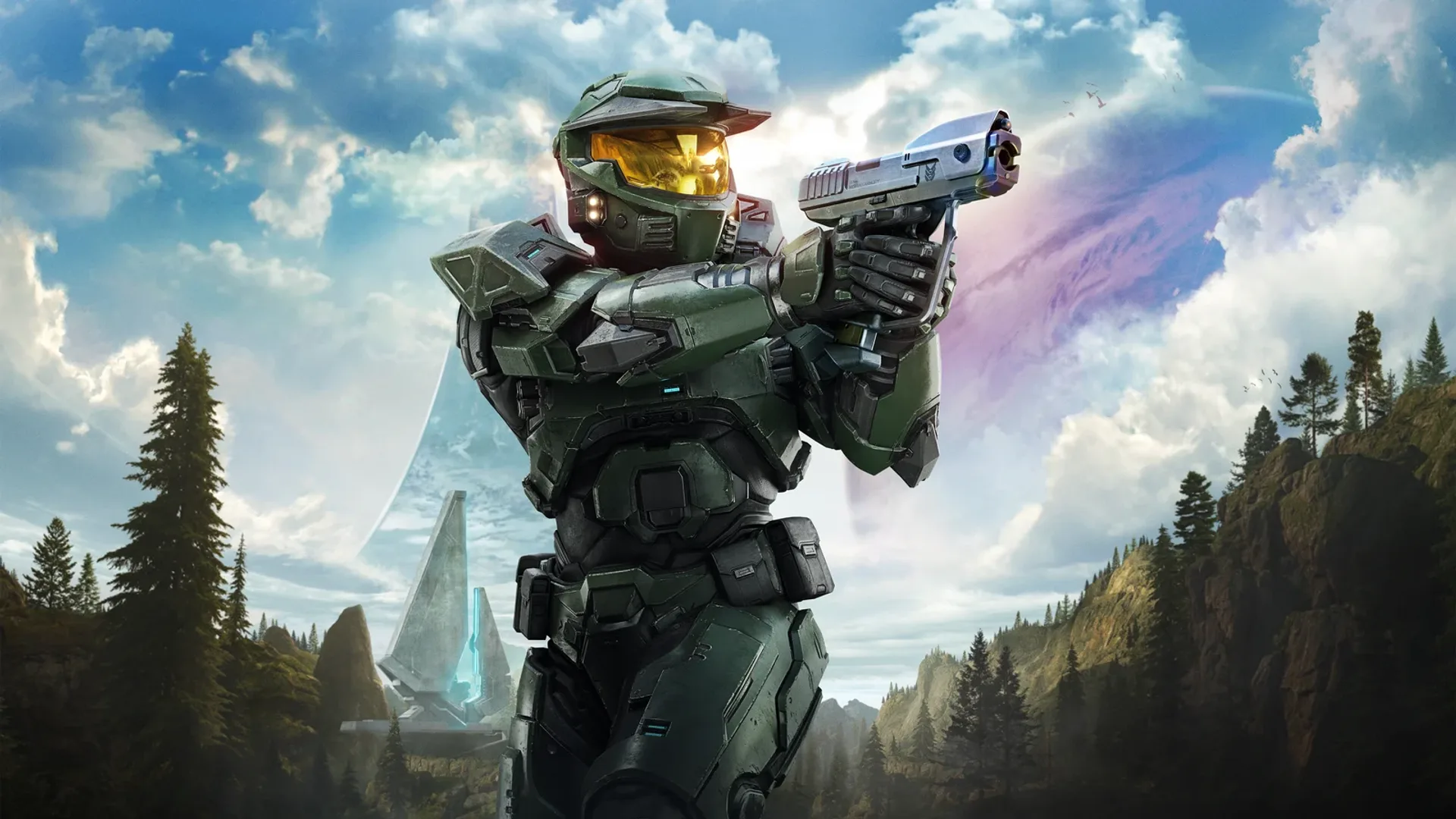Master Chief con pistola ante un valle boscoso y el anillo Halo al fondo